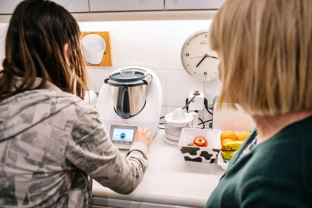 Barcelona, Spain, 15 January, 2021: Two women using thermomix at home