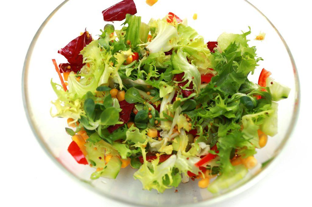 fresh salad in a glass bowl. Salad. Organic food. Healthy vegetable salad with escarole endive