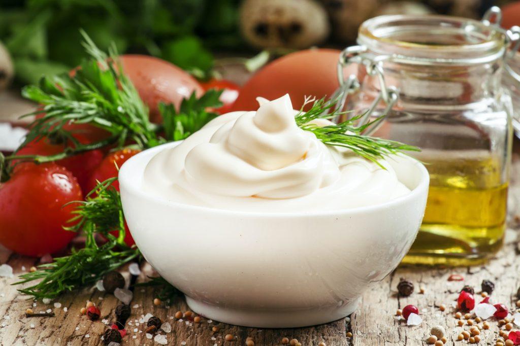 Homemade mayonnaise sauce in a white bowl