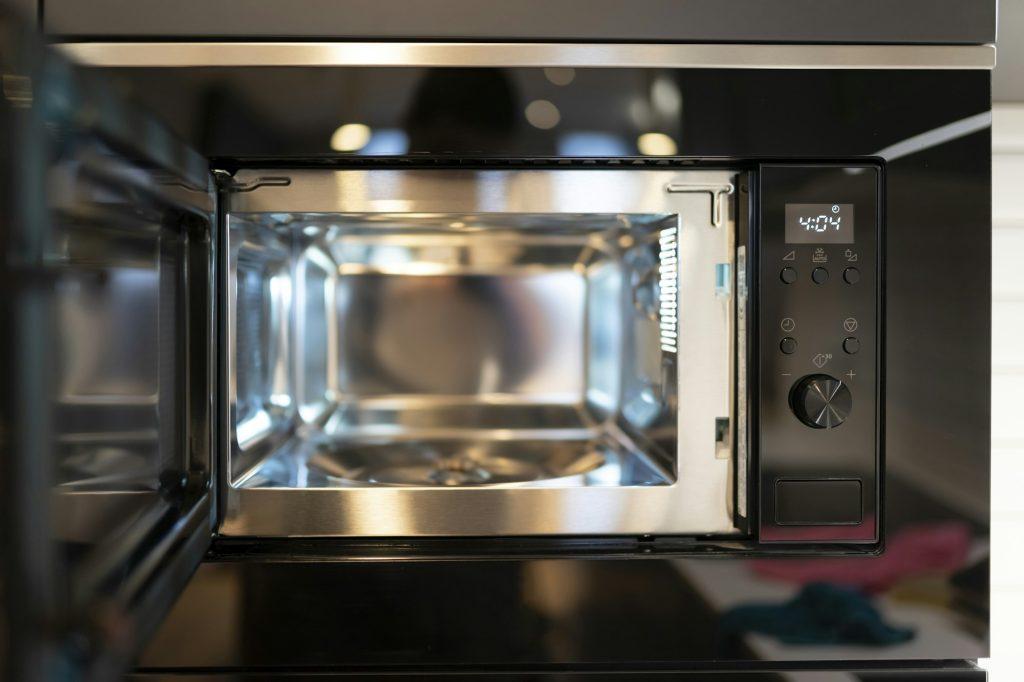 Modern built-in microwave microwave oven with open door. Empty microwave concept