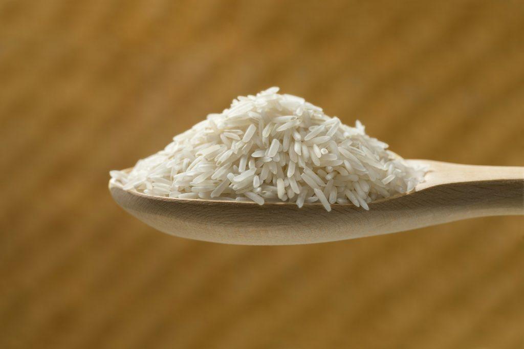 Wooden spoon with basmati rice